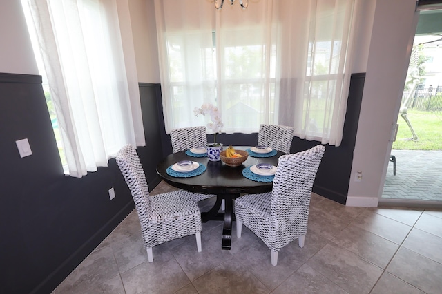 dining room featuring light tile patterned flooring and baseboards