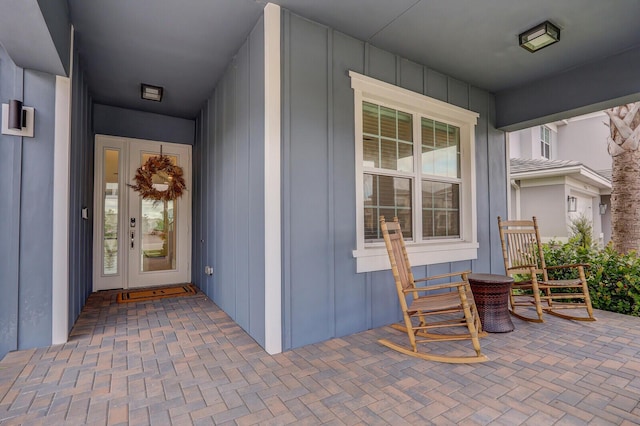 entrance to property featuring covered porch and board and batten siding