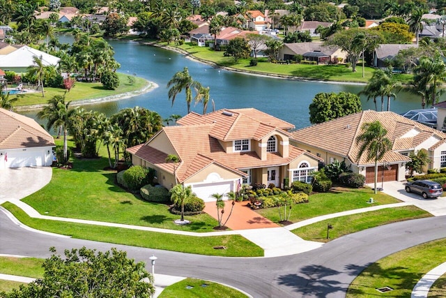 birds eye view of property with a water view and a residential view