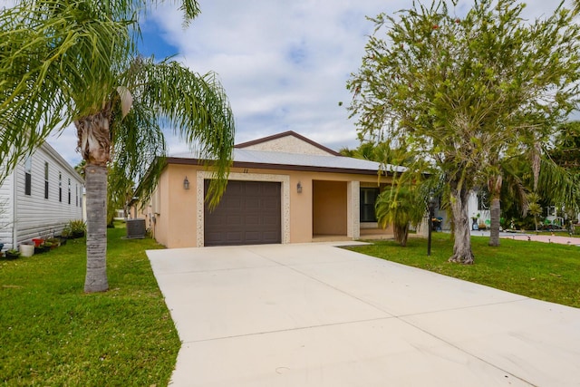 view of front of house with stucco siding, concrete driveway, an attached garage, a front yard, and cooling unit