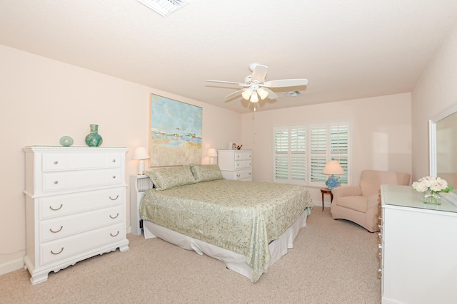 bedroom featuring light colored carpet, visible vents, ceiling fan, and baseboards