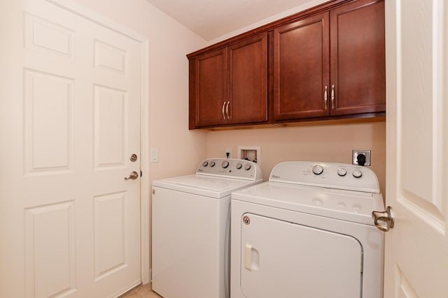 washroom featuring cabinet space and separate washer and dryer