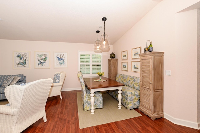 dining space featuring dark wood-style floors, vaulted ceiling, and baseboards