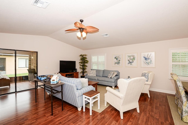 living room featuring lofted ceiling, ceiling fan, visible vents, and dark wood finished floors