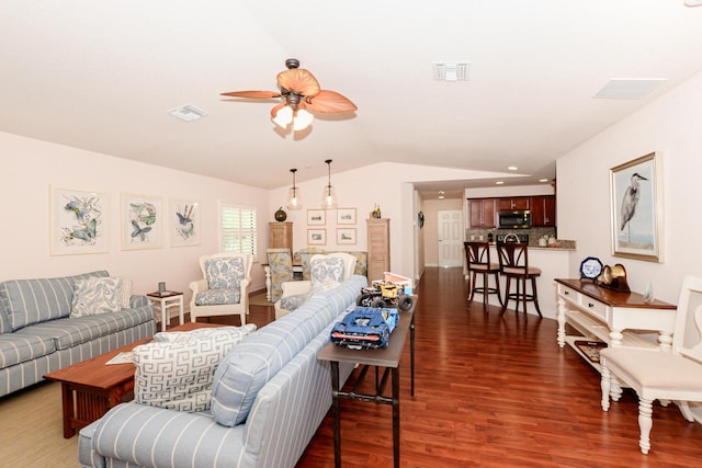 living room with vaulted ceiling, ceiling fan, dark wood-style floors, and visible vents