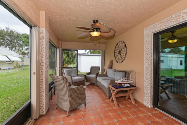 sunroom with a ceiling fan