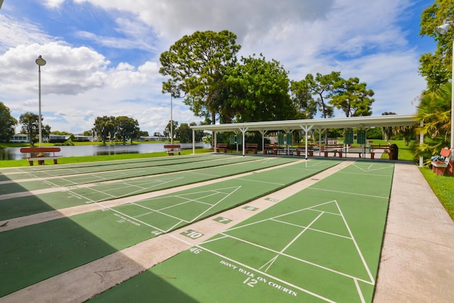 view of community with a water view and shuffleboard