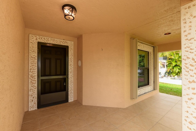 entrance to property featuring stucco siding