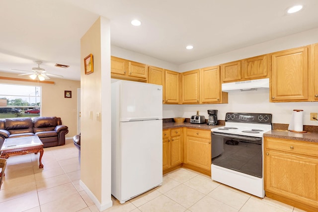 kitchen with visible vents, range with electric cooktop, dark countertops, freestanding refrigerator, and under cabinet range hood