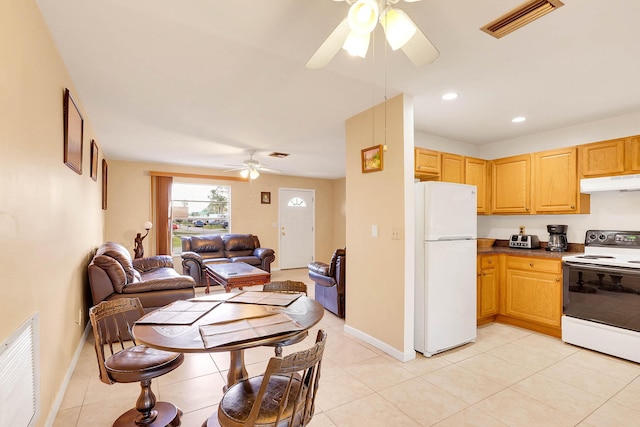 kitchen with open floor plan, white appliances, visible vents, and under cabinet range hood