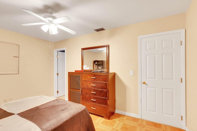 bedroom with baseboards, visible vents, and a ceiling fan