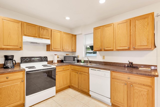 113 SW Starfish Ave, Port Saint Lucie, FL 34984 - kitchen with white appliances, under cabinet range hood, a sink, light tile patterned flooring, and dark countertops