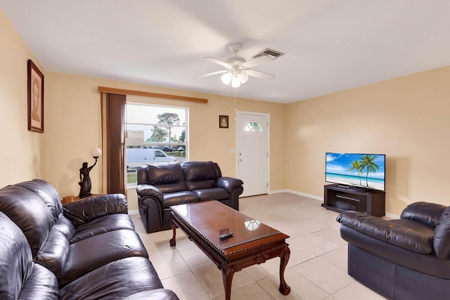 living area with a ceiling fan, light tile patterned flooring, visible vents, and baseboards