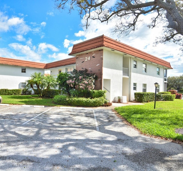 view of property featuring uncovered parking