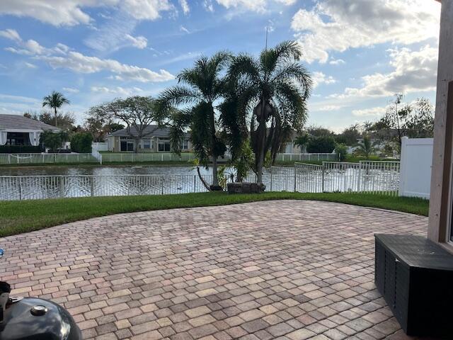 exterior space with a water view and fence private yard