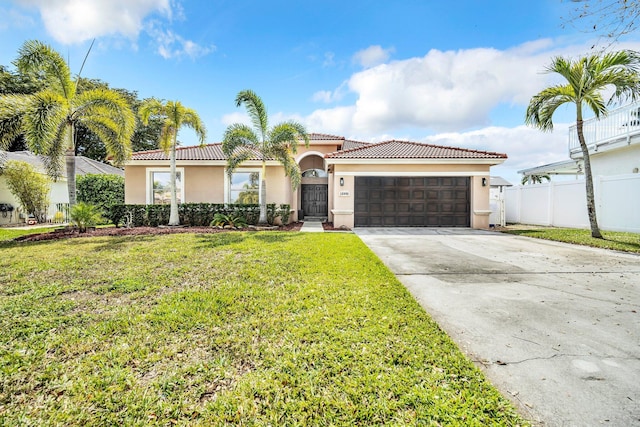 view of front of property featuring concrete driveway, an attached garage, fence, a front lawn, and stucco siding