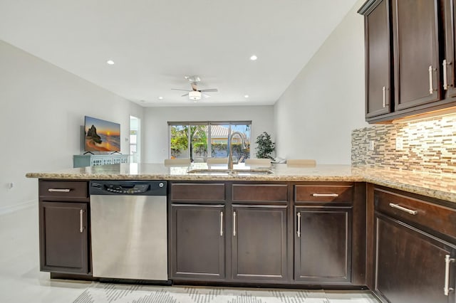 kitchen with a peninsula, a sink, dark brown cabinets, stainless steel dishwasher, and decorative backsplash