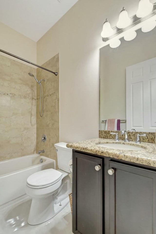 bathroom featuring tub / shower combination, vanity, toilet, and tile patterned floors