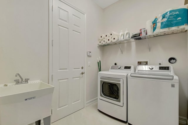 laundry area featuring a sink, laundry area, and washing machine and clothes dryer