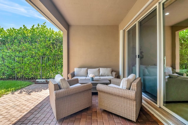 view of patio / terrace featuring outdoor lounge area and fence