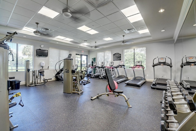 gym featuring ornamental molding, visible vents, and plenty of natural light