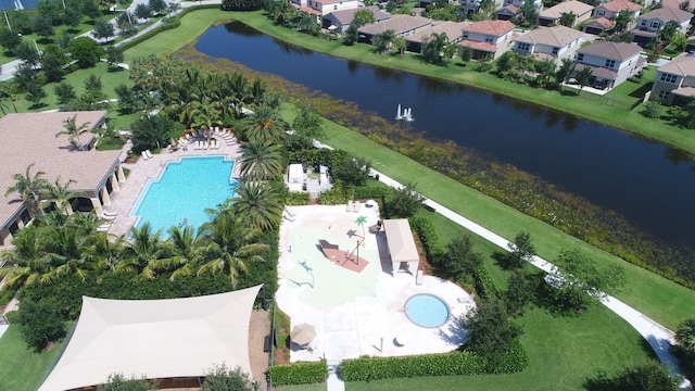 drone / aerial view featuring a water view and a residential view