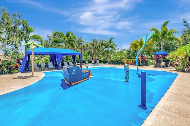 community pool with a patio and a gazebo