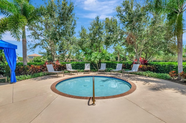 view of pool featuring a patio, a swimming pool, and fence