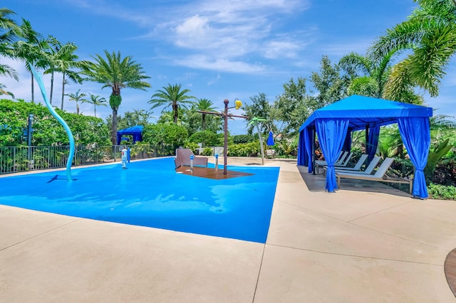 view of swimming pool featuring a gazebo and fence