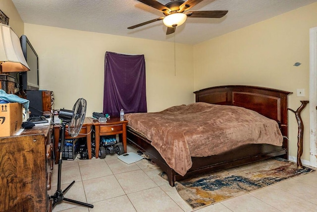 bedroom with light tile patterned floors, a textured ceiling, and a ceiling fan