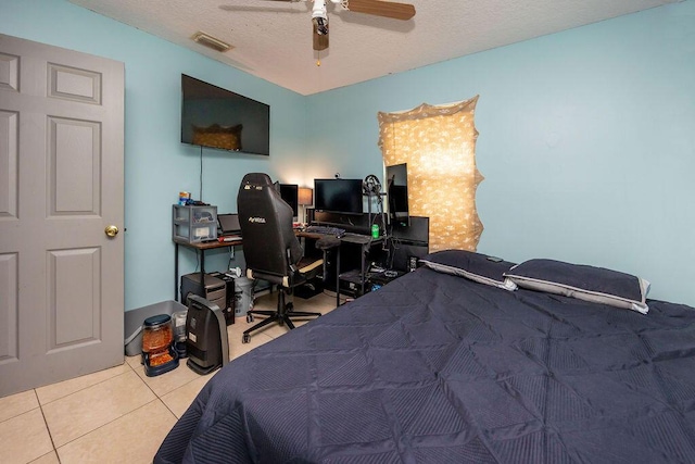 tiled bedroom with a ceiling fan, visible vents, and a textured ceiling