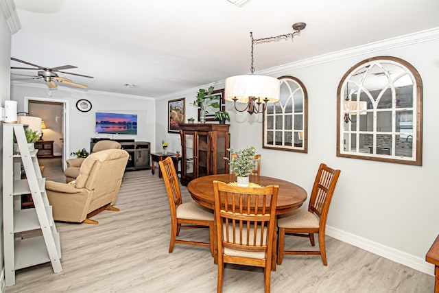 dining space with ornamental molding, baseboards, and light wood finished floors