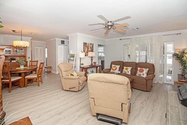 living room featuring light wood finished floors, visible vents, and a wealth of natural light