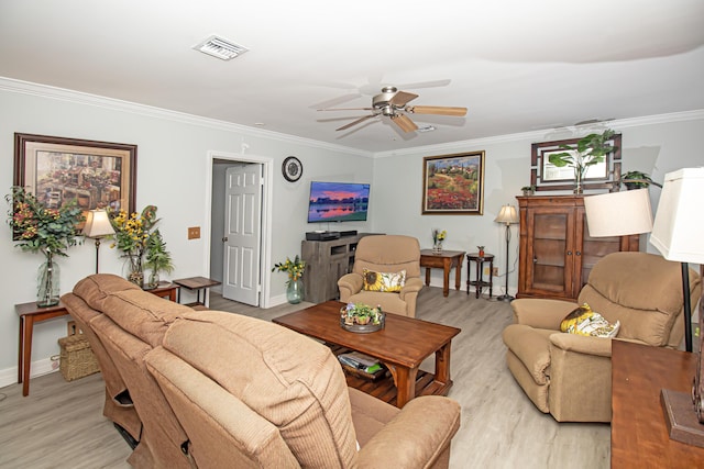 living room with crown molding, light wood finished floors, visible vents, ceiling fan, and baseboards