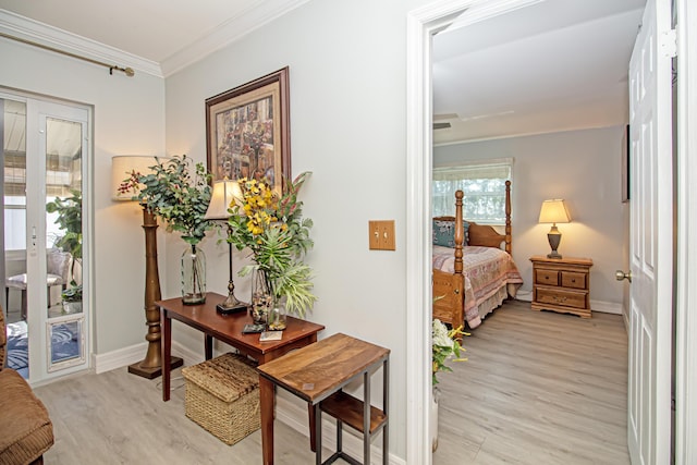 bedroom featuring access to outside, ornamental molding, light wood-style flooring, and baseboards