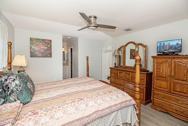 bedroom with light wood-style floors, visible vents, and ceiling fan