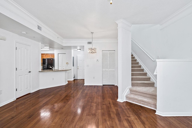 interior space featuring dark wood-type flooring, visible vents, baseboards, stairs, and ornamental molding