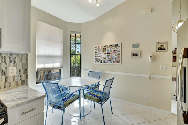 dining area with light tile patterned floors and baseboards