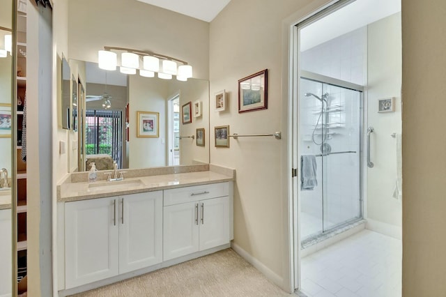 bathroom featuring a shower stall, baseboards, ceiling fan, and vanity