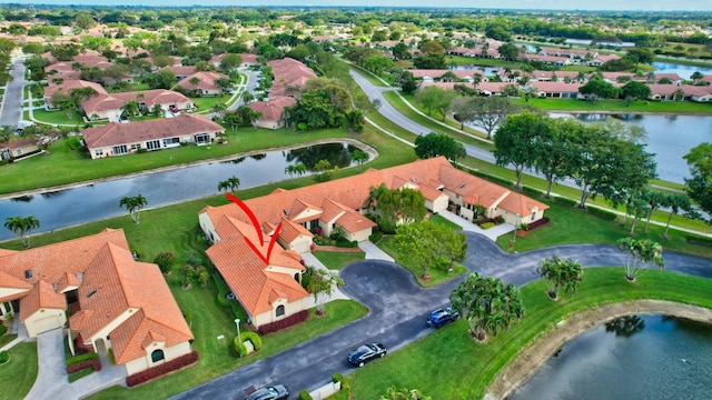 drone / aerial view with a residential view and a water view