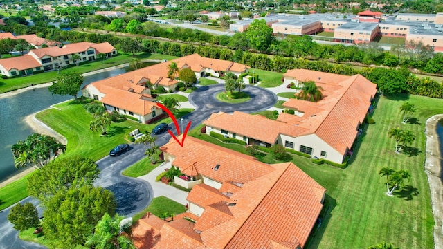 birds eye view of property with a water view and a residential view