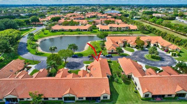 bird's eye view featuring a water view and a residential view