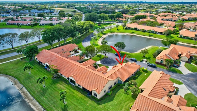 birds eye view of property with a water view and a residential view