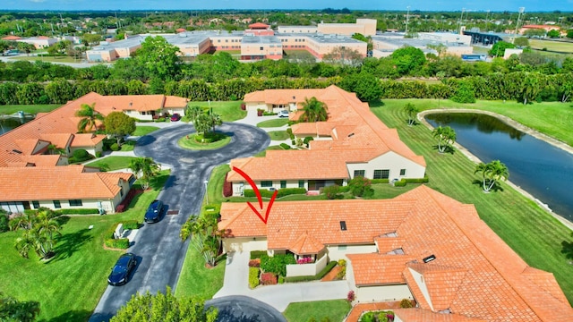 birds eye view of property featuring a water view and a residential view