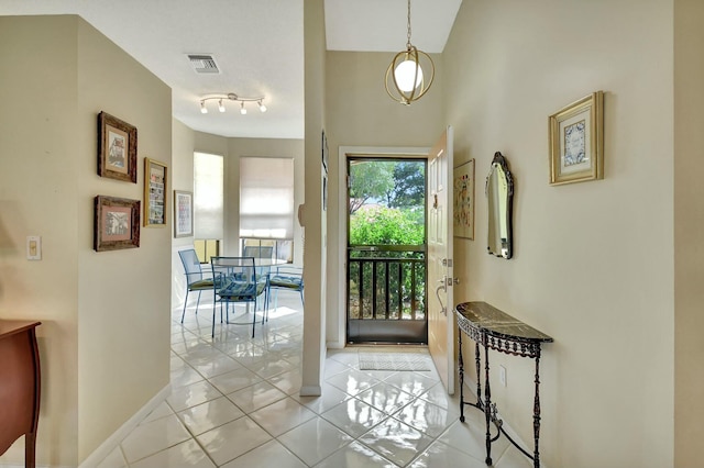 tiled entrance foyer featuring visible vents and baseboards