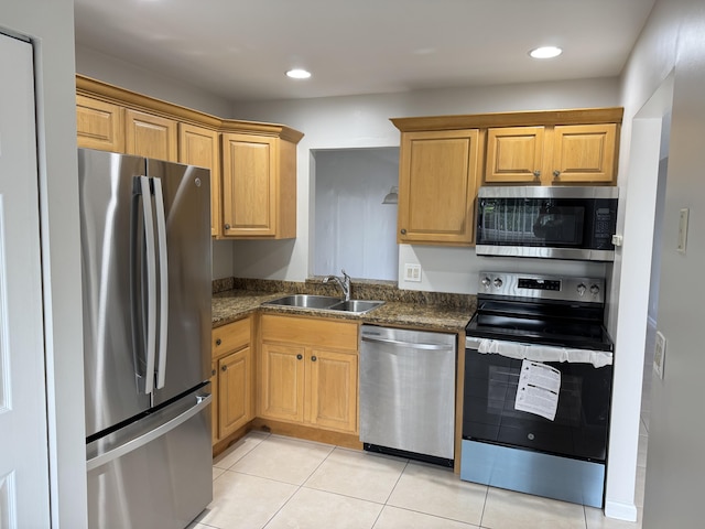 kitchen with light tile patterned floors, stainless steel appliances, recessed lighting, brown cabinetry, and a sink