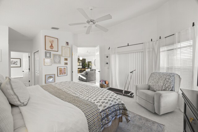 carpeted bedroom featuring baseboards, lofted ceiling, and a ceiling fan