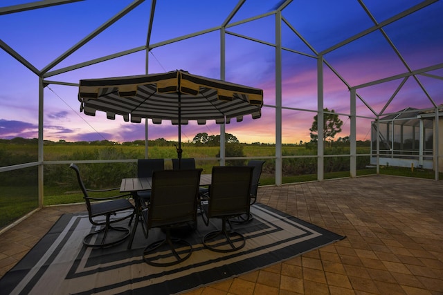 view of patio with glass enclosure and outdoor dining area