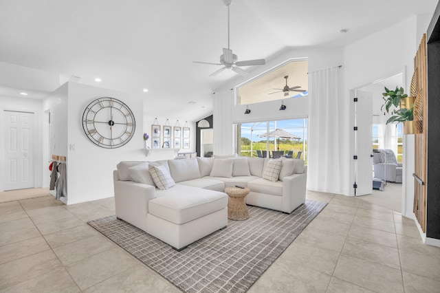 living room featuring light tile patterned floors, visible vents, vaulted ceiling, and a ceiling fan