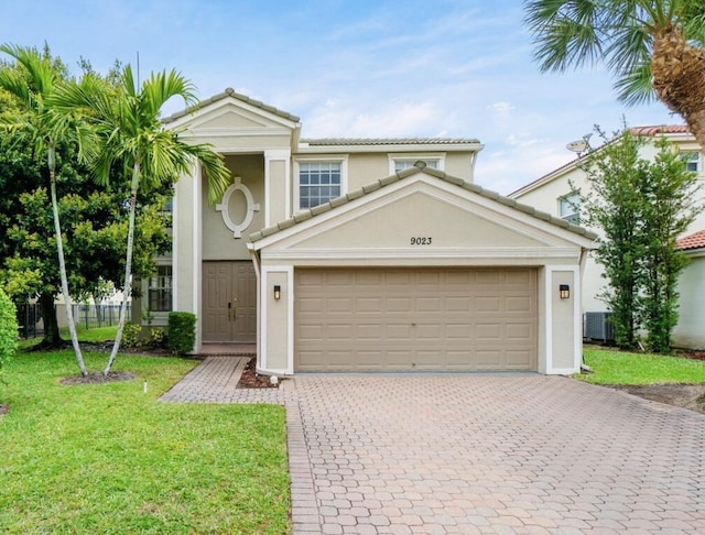 view of front of property featuring an attached garage, a tile roof, decorative driveway, stucco siding, and a front lawn